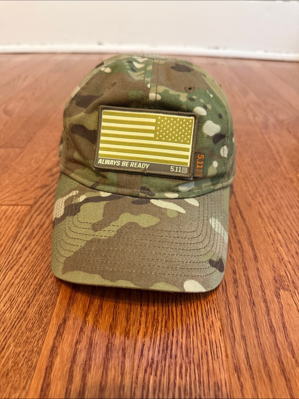 Camouflage cap on wooden floor